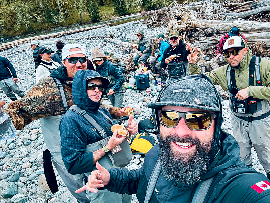 Guides celebrating on the riverbank