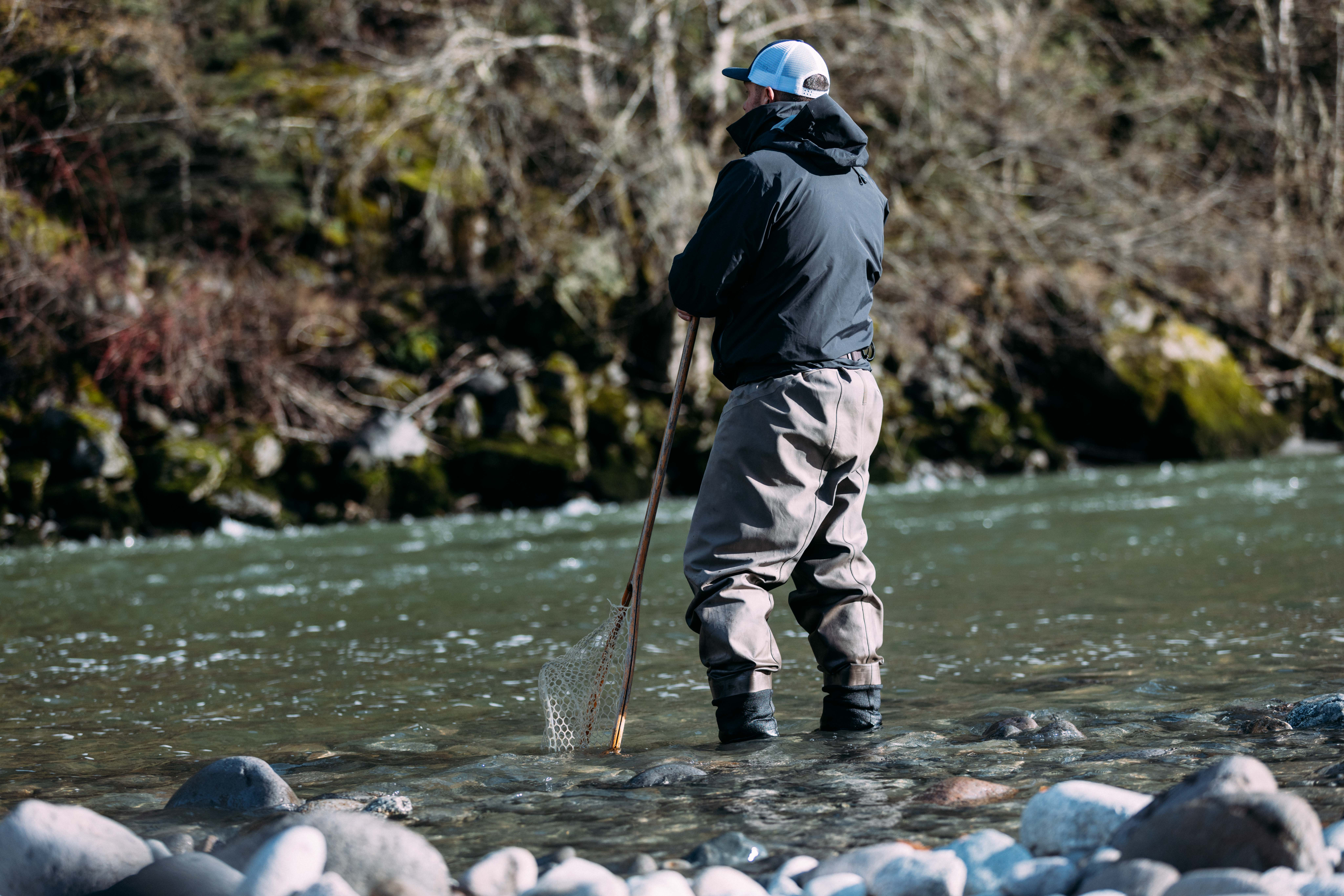 Fly fishing guide standing in river